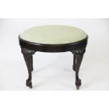 A George II style carved mahogany oval stool,