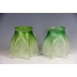 A near pair of Edwardian graduated green to clear frosted glass light shades,