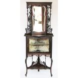 A late Victorian carved mahogany corner cabinet, with mirrored door above a glazed door,