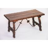 A Spanish style pine occasional table, with wrought iron frame, 47cm H x 90cm W x 45cm D,