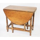 A 1920's oak gate leg table, on turned legs, 73cm H x 90cm W,