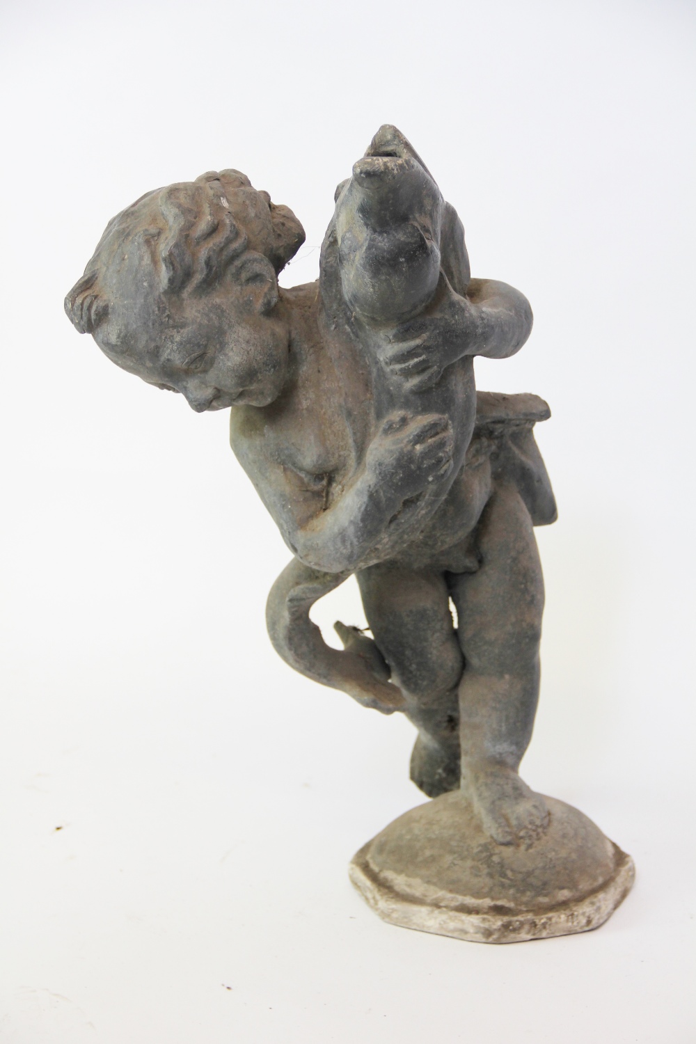 A 19th century lead fountain, modelled as a cherub with a dolphin, on octagonal base,