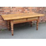 A Victorian pine kitchen table, three plank top with cleated ends, two dummy drawers,