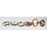 A 9ct gold and garnet set double snake ring, a 9ct gold turquoise set ring, a 9ct gold cameo ring,