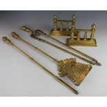 A Victorian brass three piece companion set, with spiral fluted shovel head and turned handles,
