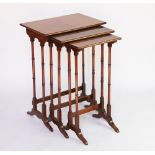 An Edwardian walnut triple nest of tables, with quarter veneered top,