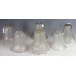 A collection of six Victorian and Edwardian frosted glass light shades, with etched detailing,