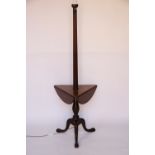 An early 20th century mahogany standard lamp with fluted column and a trifold table to centre and