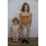 A large wooden peg doll with painted features,