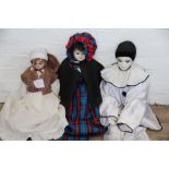 A wax over papier mache head doll with glass eyes porcelain limbs, and cloth body,