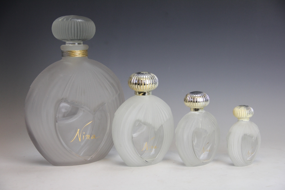 A graduated set of four Lalique for Nina glass scent bottles, to include a large display example,