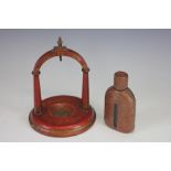 A pocket watch stand, 19th century, red painted and gilt decorated,