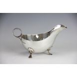 A silver sauce boat, H Pidduck & Sons, Sheffield 1936, of low oval form and with ring handle,