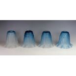 A set of four Art Nouveau graduated blue to clear glass light shades,