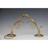 A pair of cast brass wall lights, with scroll arms,