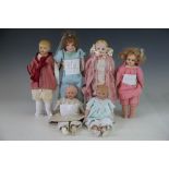 A collection of six small dolls, to include; a WWI porcelain boy doll, 31cm overall,