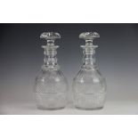 A pair of Regency triple rim neck cut glass decanters and stoppers, with hob nail detailing,