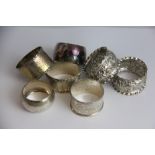 Four silver napkin rings,