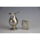 A silver pouring jug, London 1900, of baluster form 7.