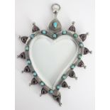 An Indian silver hanging frame, the heart shaped, glazed frame set with turquoise and garnets,