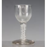 A late 18th century style glass drinking glass, with double opaque twist stem, on a thick foot,