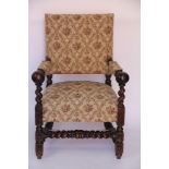 A late Victorian carved oak hall chair, with upholstered back, arms and seat,