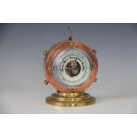 An early 20th century copper and brass aneroid barometer,