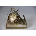 A brass combination barometer, thermometer and compass, modelled as a ships wheel,