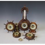 A collection of six barometers, to include a late Victorian walnut example with inset barometer,