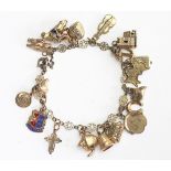 A yellow metal decorative link bracelet, stamped '9ct', with attached charms, to include; a church,