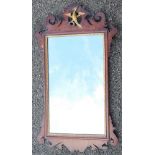 An 18th century walnut fret frame mirror, with phoenix surmount,