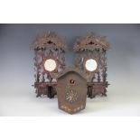 Two Black Forest carved wood wall brackets, with mirror backs, 36cm,