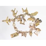 A 9ct yellow gold bracelet with attached charms, to include; an elephant, a Mini car, an aeroplane,