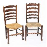 A matched set of six 19th century oak and ash ladder lack dining chairs, with rush seats,