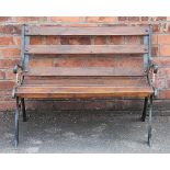 A cast iron garden seat, with trellis style back and a cast iron two seater garden bench,
