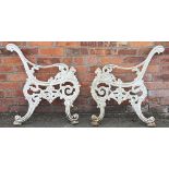 A pair of Victorian cast iron garden bench ends, cast with lions heads,