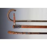 An Edwardian walking cane, the handle with screw fitting enclosing a pipe,