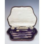 A cased silver manicure set, 'CD' London 1916, comprising; buffers, jars, tools, scissors,