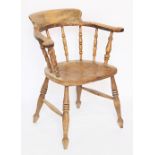 A late 19th century beech, ash and elm Captain's type chair,