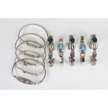 A collection of ten assorted bangles, to include Celtic woven examples and gem set examples,