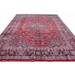 A large Persian hand woven wool carpet, worked with an all over foliate design,