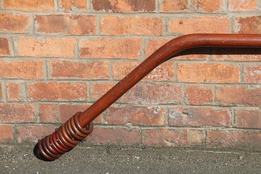 An early 20th century bay window curtain pole, with tuned finial ends,