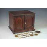 A Victorian mahogany table top cabinet, with two doors enclosing three drawers,