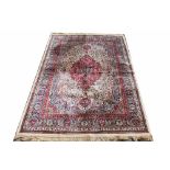 A Kashmir rug, worked with an all over foliate design against an ivory ground,