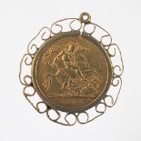 An Edward VII gold half Sovereign dated 1904, within scroll pendant mount, 5.