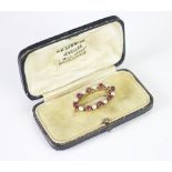 A tourmaline and untested pearl oval garland brooch,