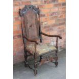 A Carolean carved oak and beech arm chair,