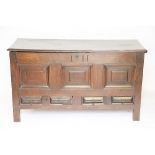 An early 18th century oak mule chest, with triple panelled front above two fielded drawers,