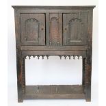 A late 17th century style carved oak livery cupboard,