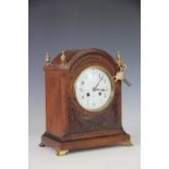 An Edwardian carved oak mantel clock, with Arabic enamel dial and movement striking on a gong,